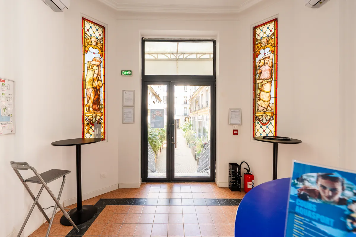 Entrance hall of the Oberkampf clinic in Paris with two Art Nouveau stained-glass panels